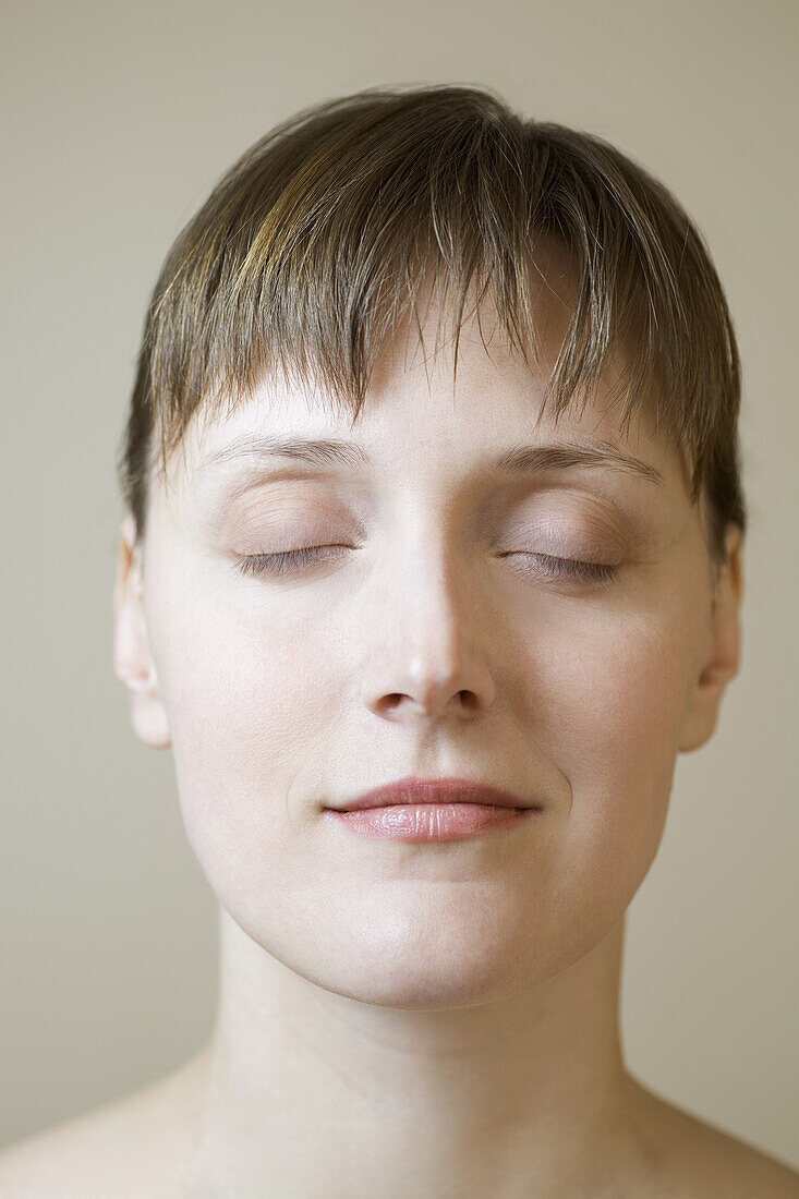 A woman with her eyes closed, close-up