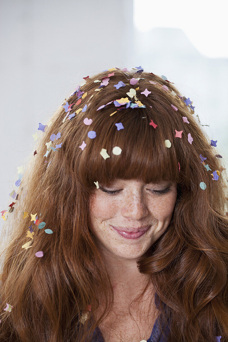 A young woman with confetti in her hair