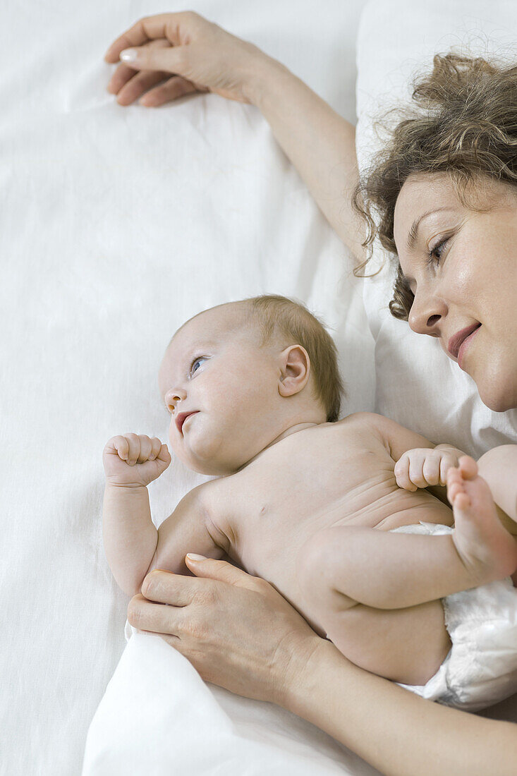 Mother and daughter on bed