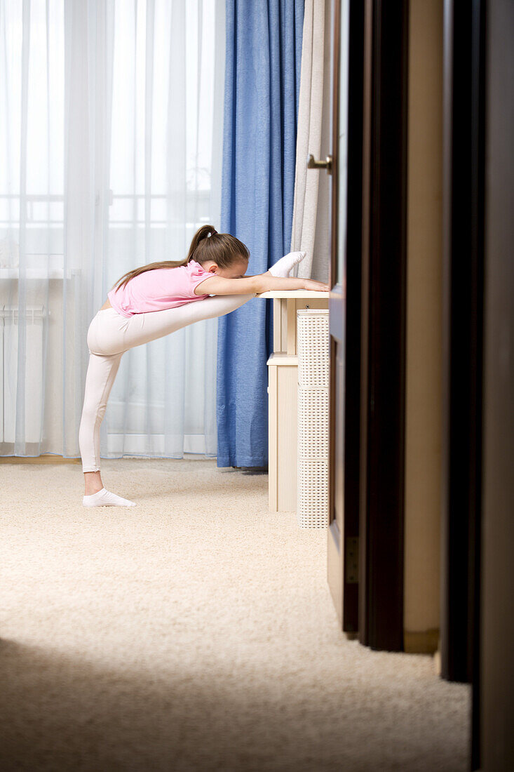 Girl practicing ballet in her room