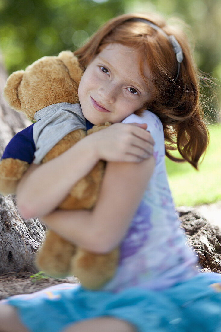 Girl hugging teddy bear