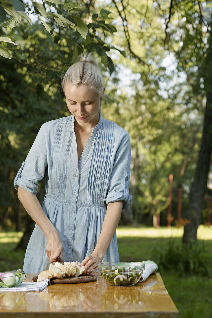 A woman preparing a healthy meal outdoors in the backyard