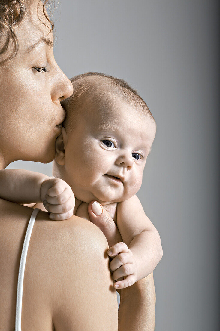 Mother kissing her child on the head