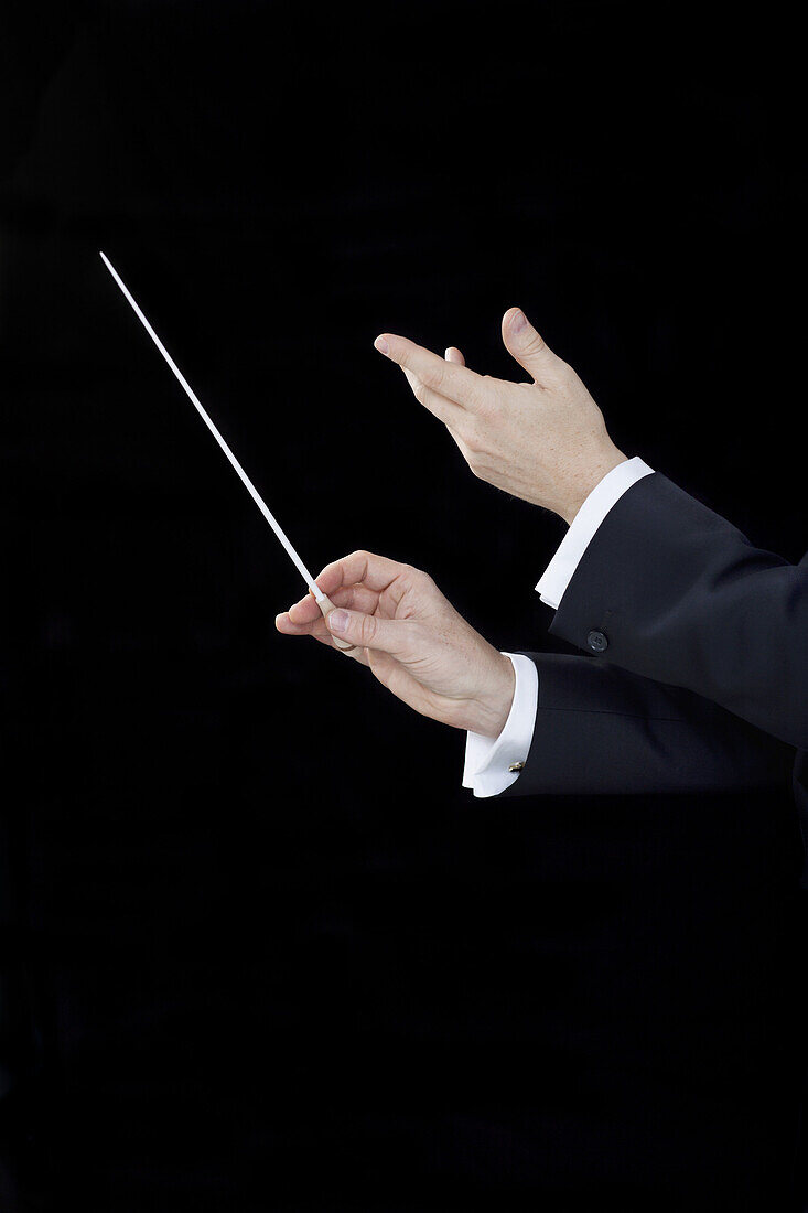 A conductor conducting, focus on hands