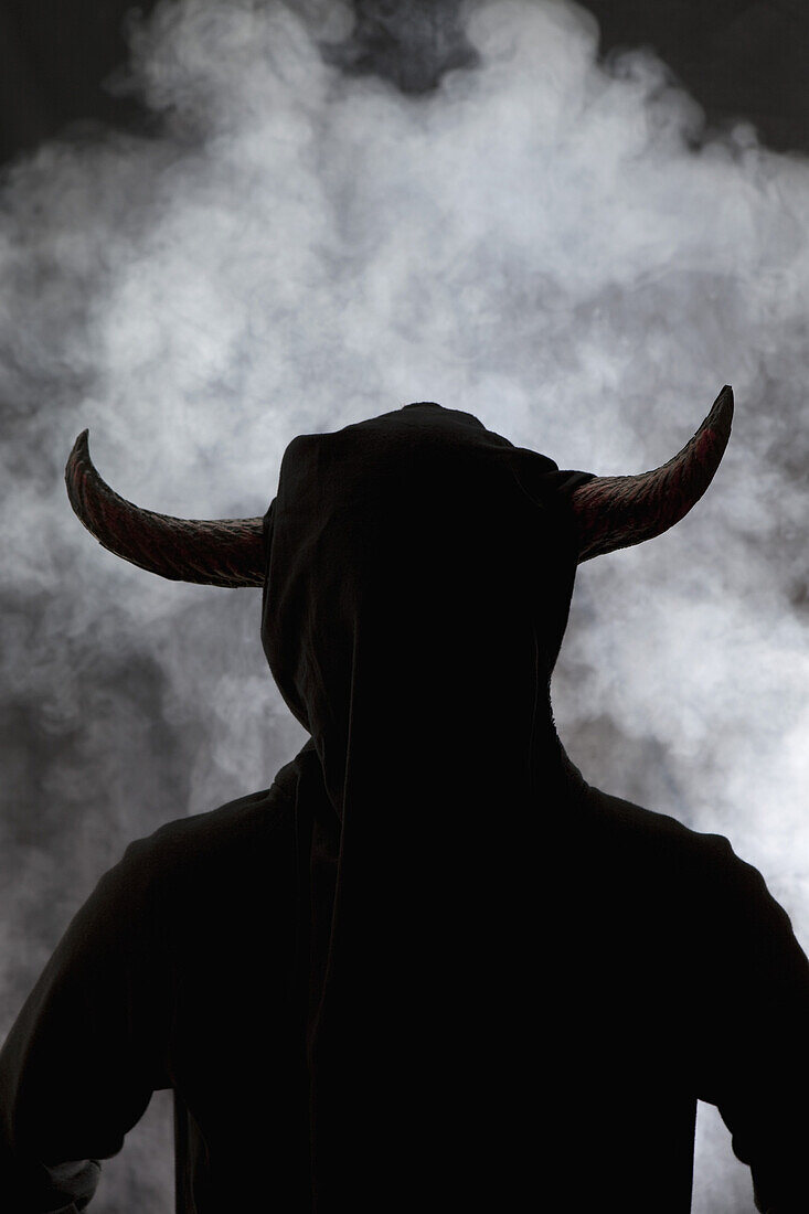 A person with horns attached to head, silhouette