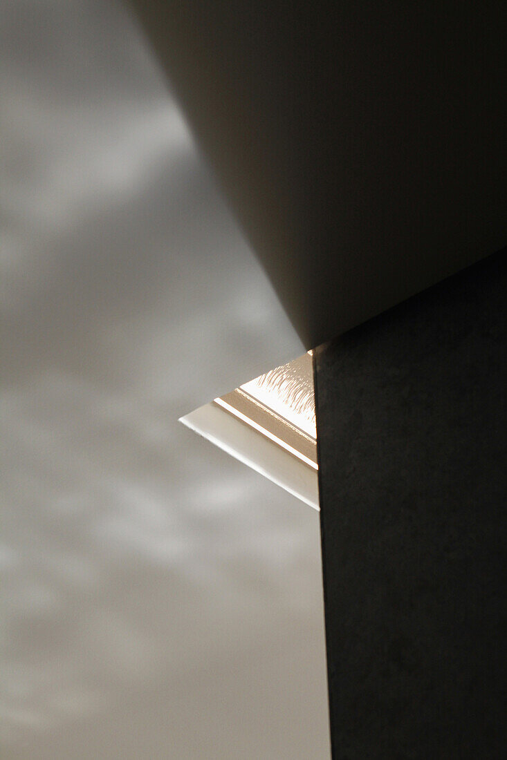 Corner of skylight surrounded by ceiling and wall