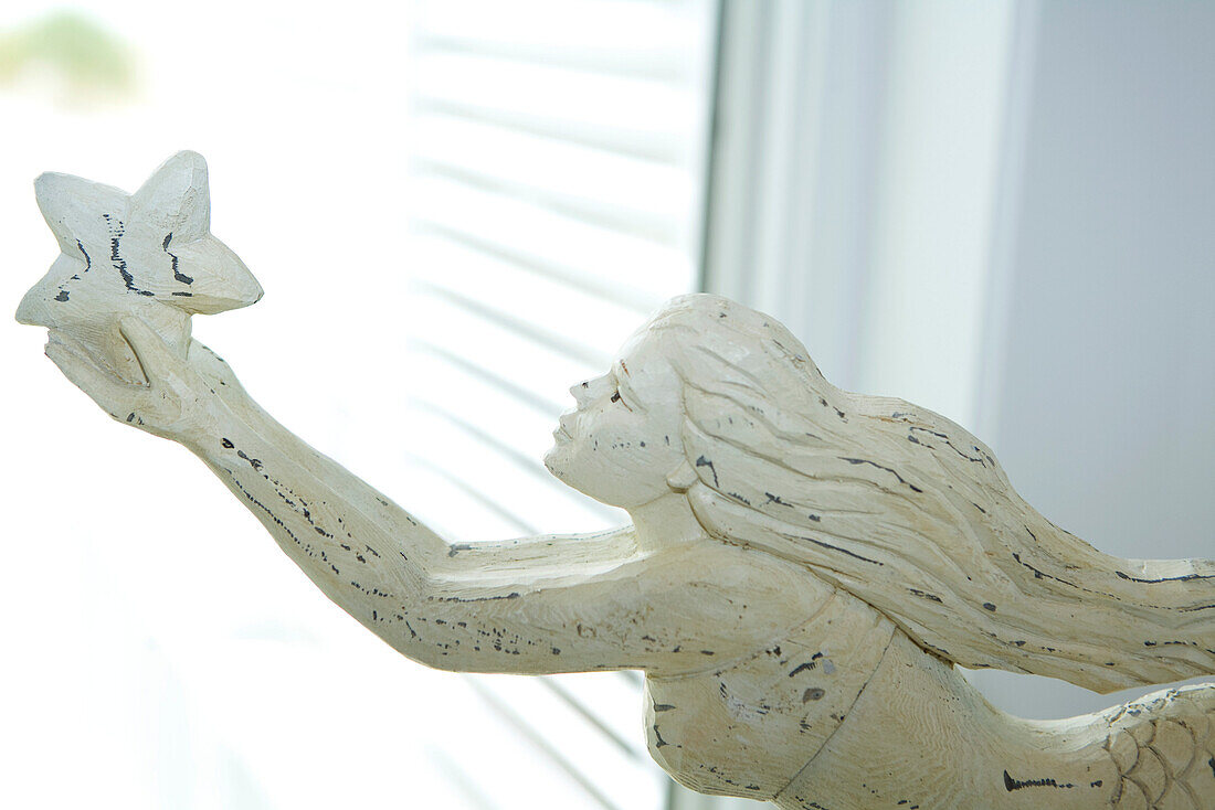 Wooden carving of mermaid, cropped