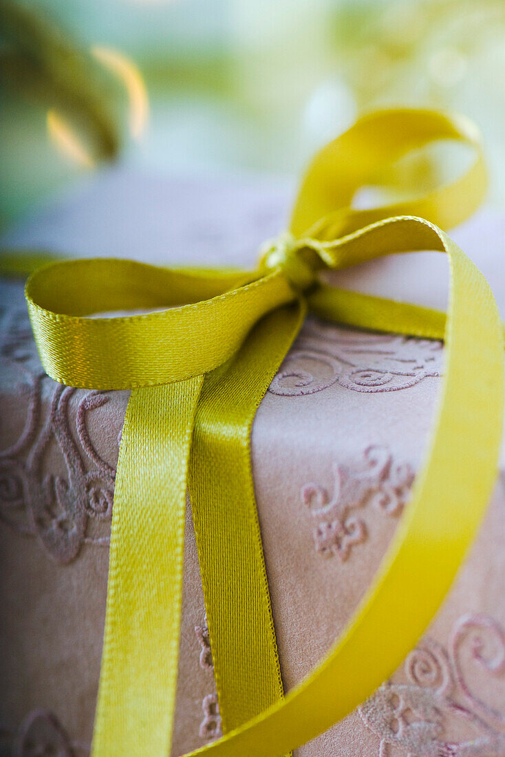 Wrapped gift tied with gold ribbon, close-up
