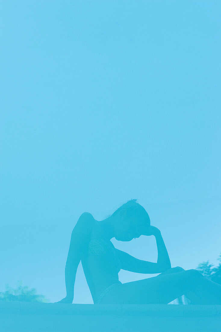 Woman reflected in surface of water