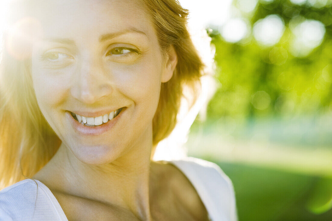 Young woman outdoors on sunny day, portrait