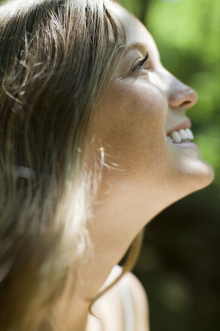 Happy young woman, side view