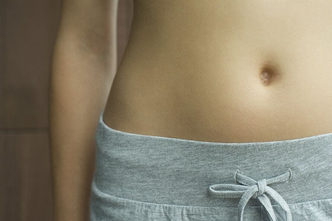 Woman's bare stomach, cropped
