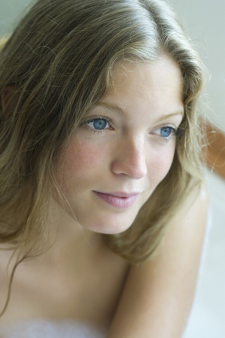 Young woman relaxing in bath, portrait