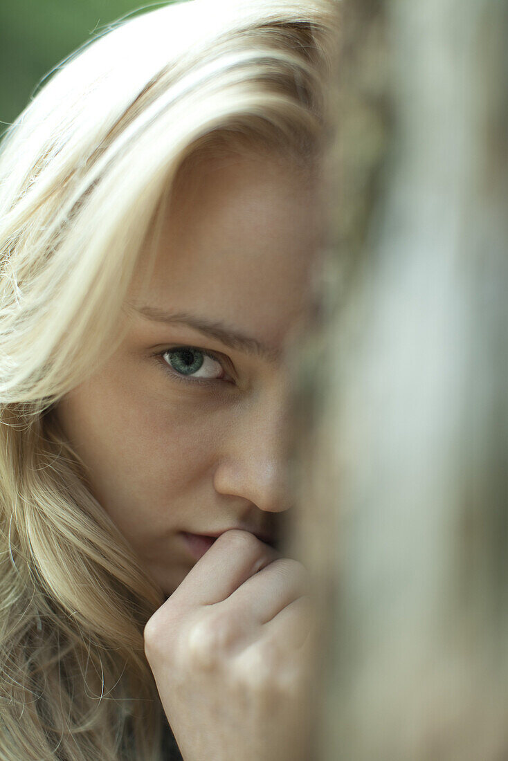 Young woman with serious expression, cropped