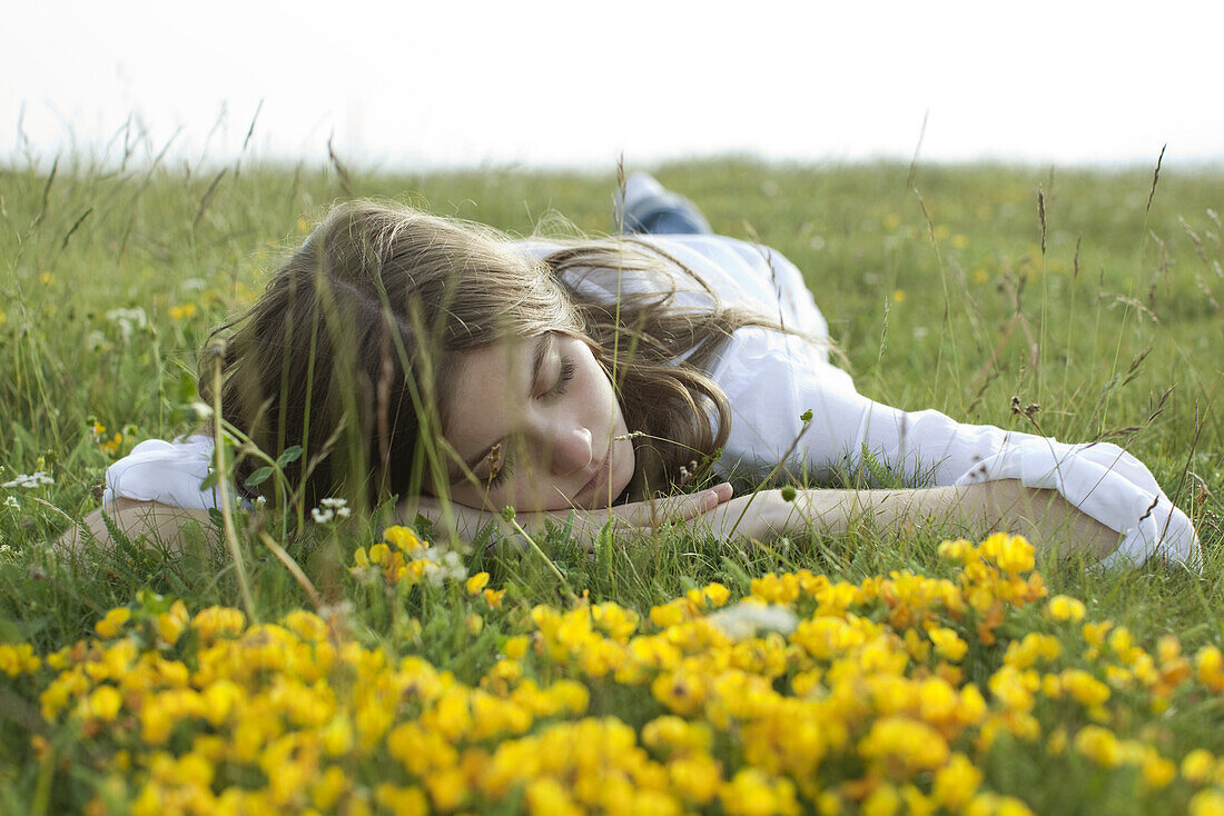 Young woman resting on meadow