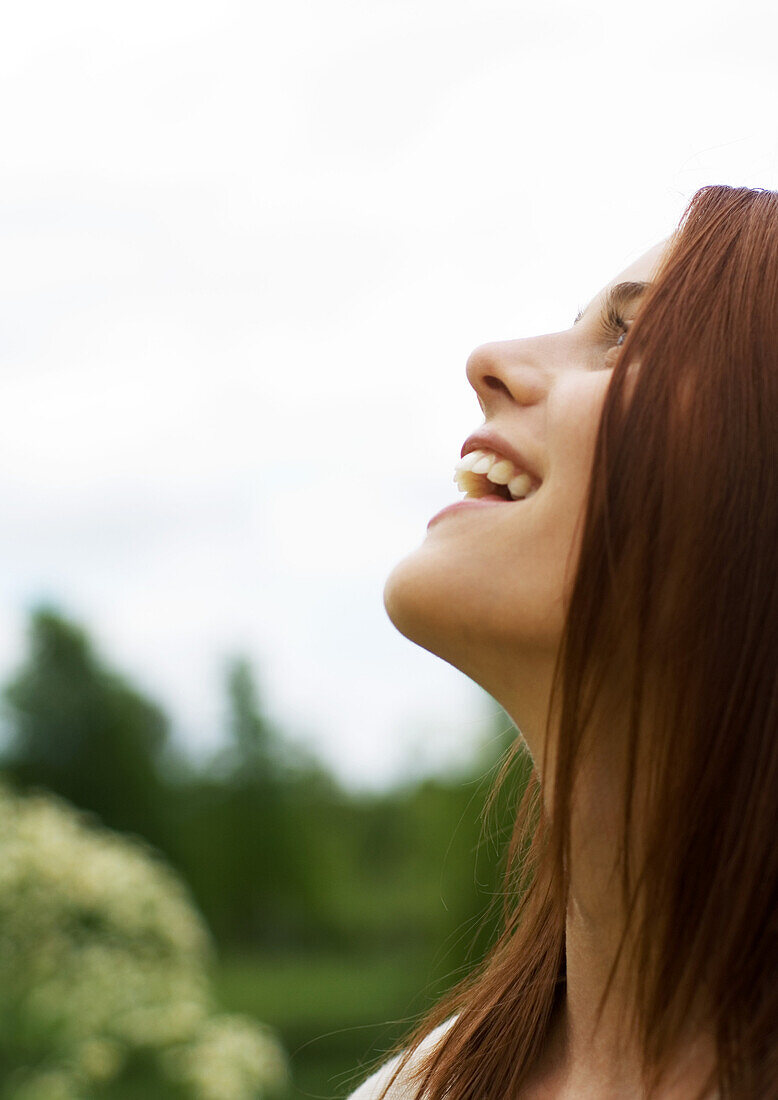 Young woman looking up and smiling