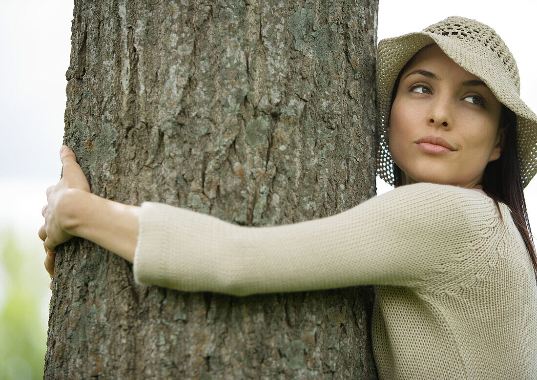 Woman hugging tree