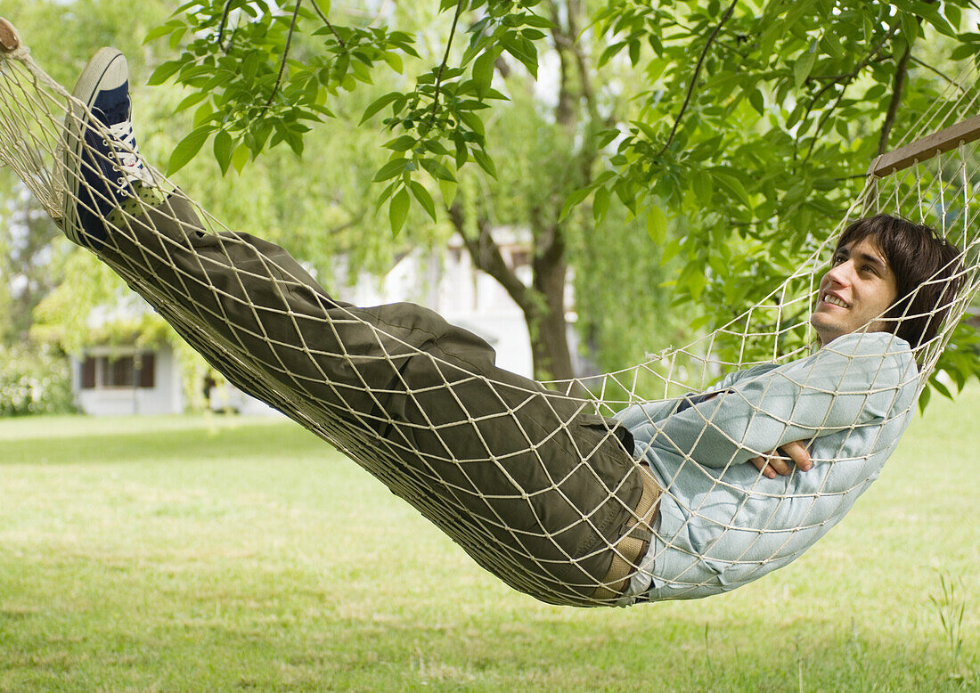 Young man lying in hammock