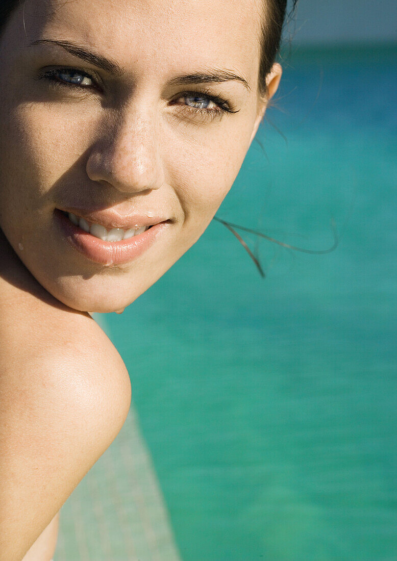 Woman's face, next to swimming pool, close-up