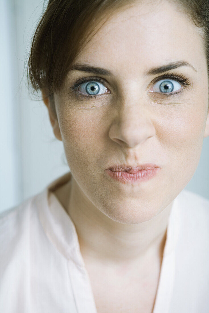 Woman making face, close-up, portrait