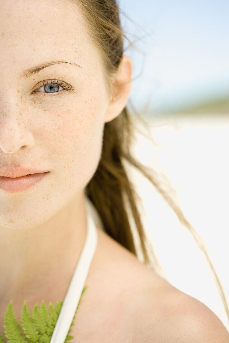 Young woman on beach, cropped view