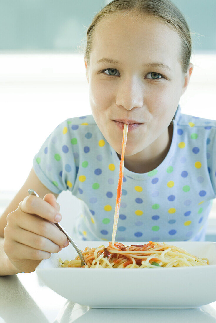 Girl slurping spaghetti noodles