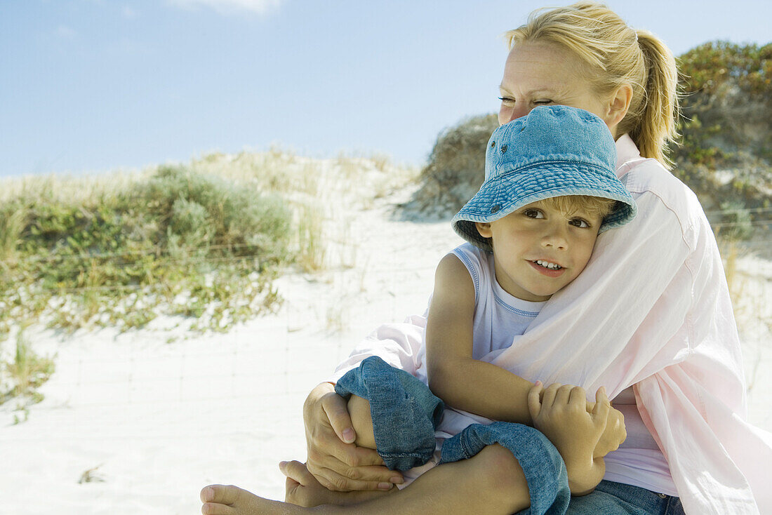 Little boy with mother on beach