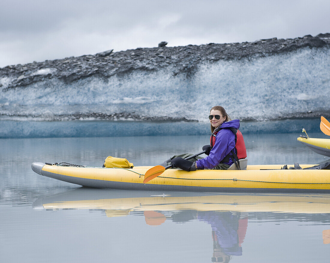 Woman kayaking at Valdez Glacier, Alaska, USA