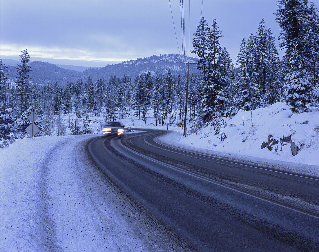 Car on snowy mountain road at Sunpeaks resort in Kamloops, British Columbia, Canada