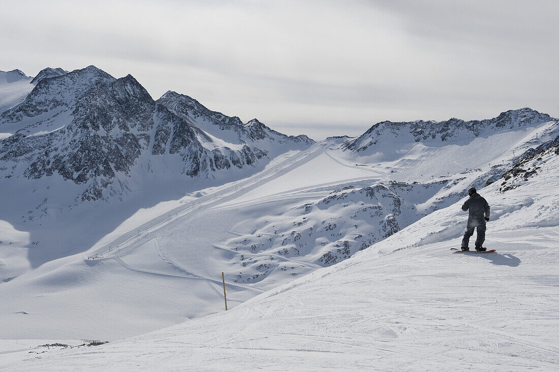 Snowboarder preparing to go down a slope