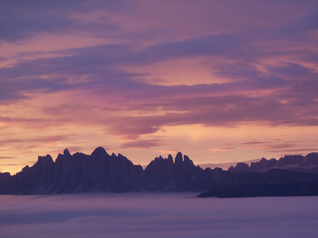 Tranquil view of purple clouds and mountains