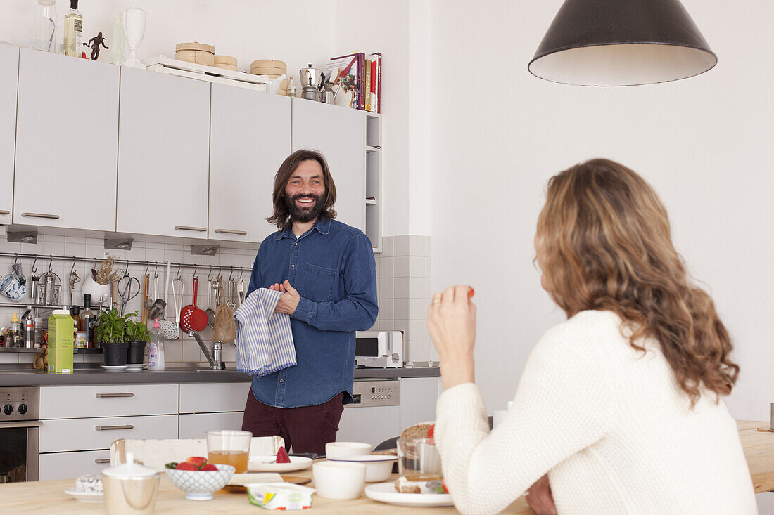 Smiling mid adult couple in kitchen