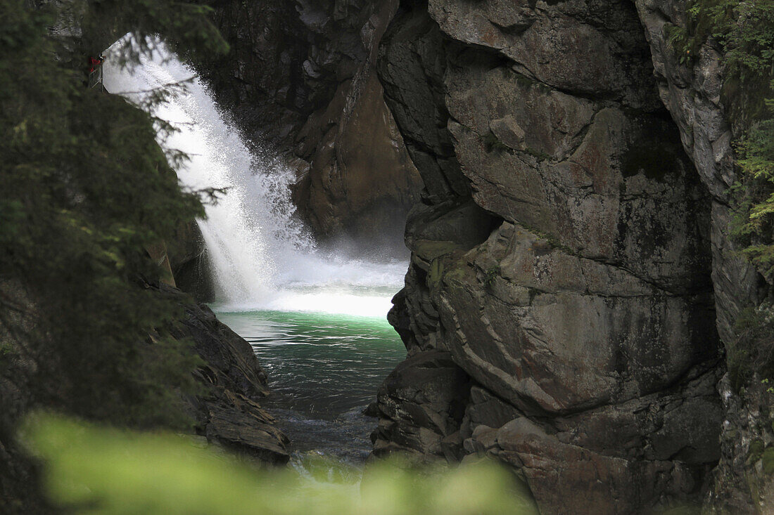 View of a waterfall through rocks