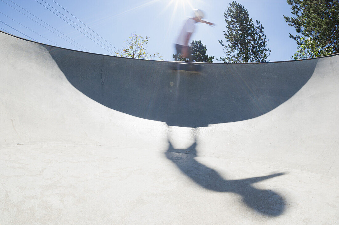 Blurred motion of skateboarder performing trick