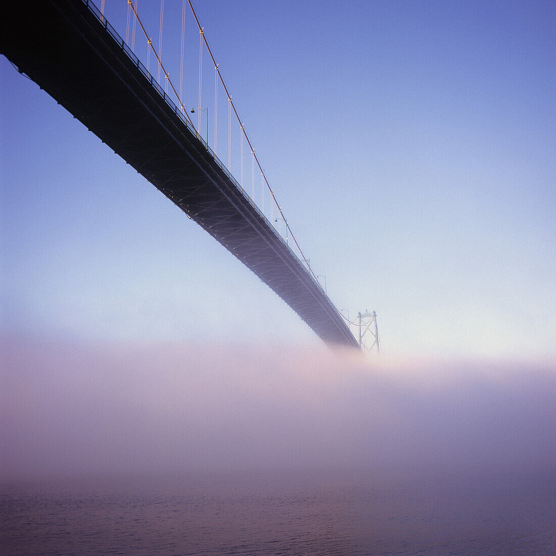 Lions Gate Bridge over sea in fog, Vancouver, Canada