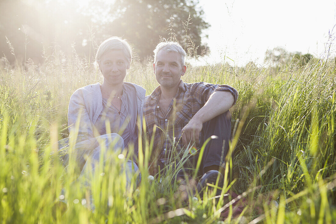 Portrait of smiling mature couple taking break from gardening
