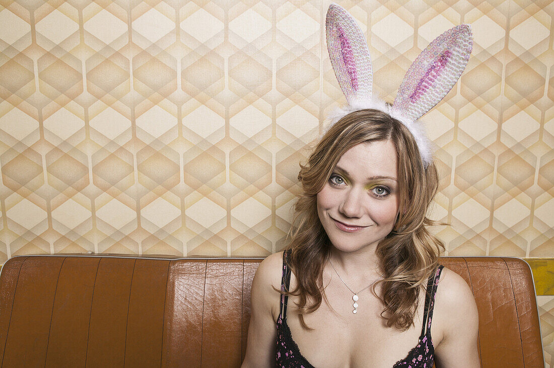 Portrait of a woman with rabbit ears, smiling