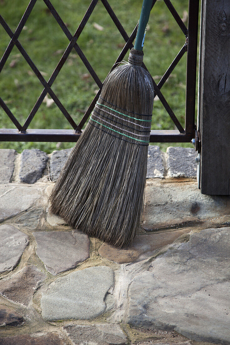 Broom leaning near railing