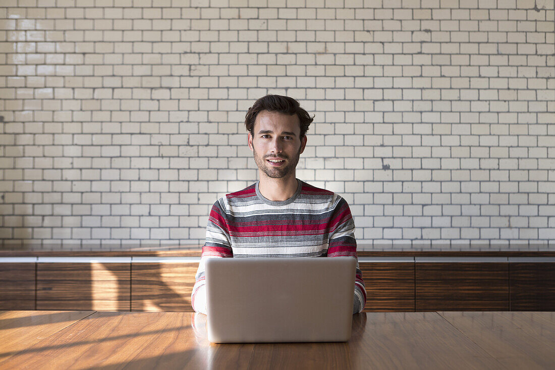 Man using laptop, portrait