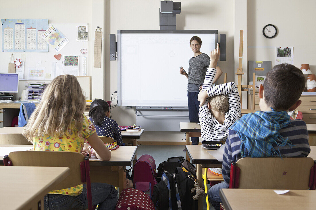 Teacher teaching to students in classroom