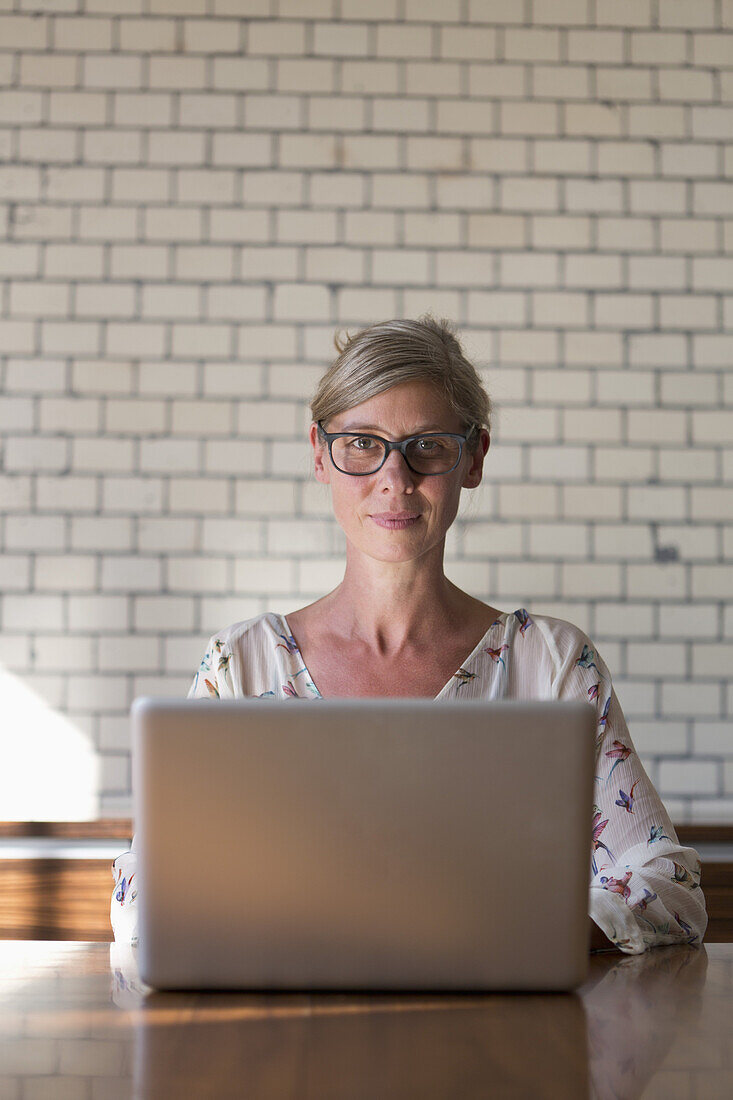 Woman using laptop, portrait