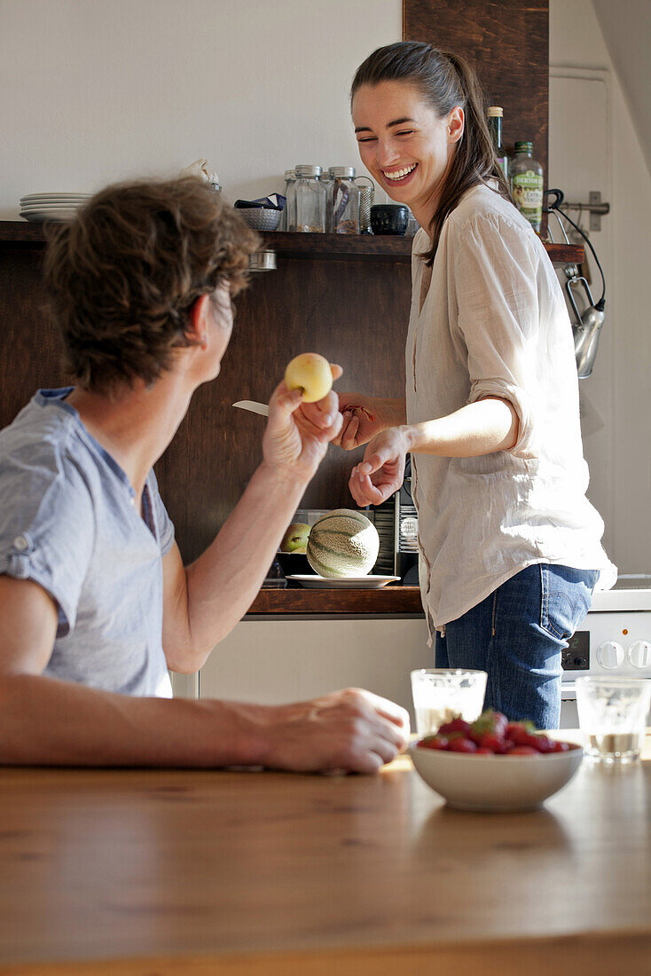 Young couple in kitchen preparing breakfast