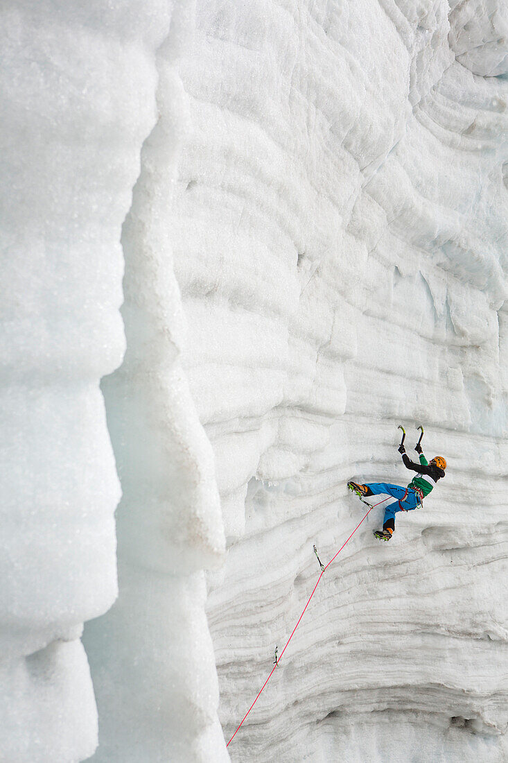 Ice climber Markus Bendler on icefall, Hintertux Glacier, Hintertux, Tyrol, Austria