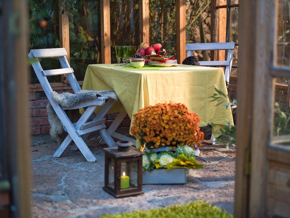 An autumnal atmosphere on a terrace set for supper for two