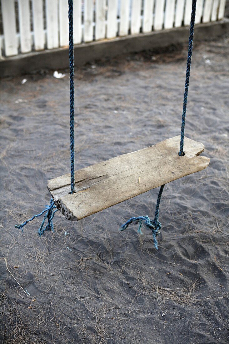 An old weathered wood swing, close-up, high angle view