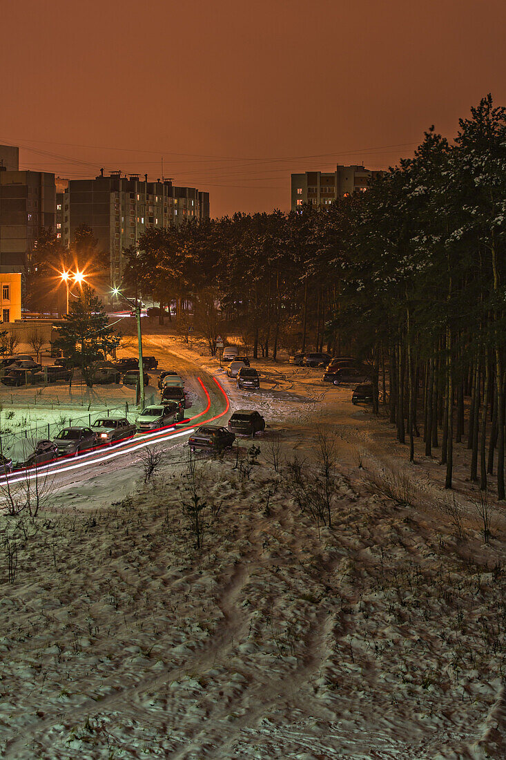 Long exposure shot of cars moving on a snowy street at night, Voronezh, Russia