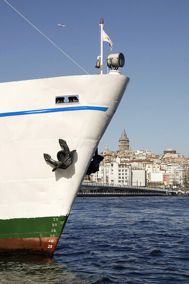 Bow of boat with background showing Galata Tower, Istanbul, Turkey