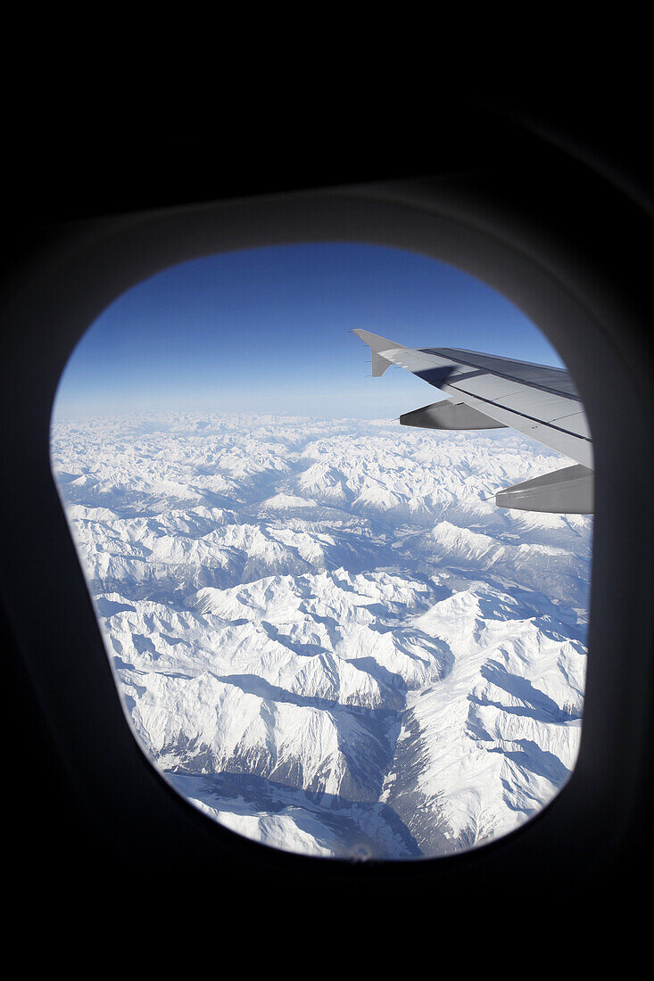 View of snowcapped Swiss Alps from an airplane