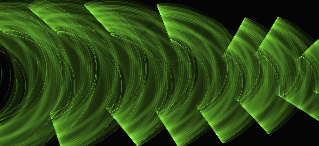 Green light trails creating an abstract wave pattern on a black background