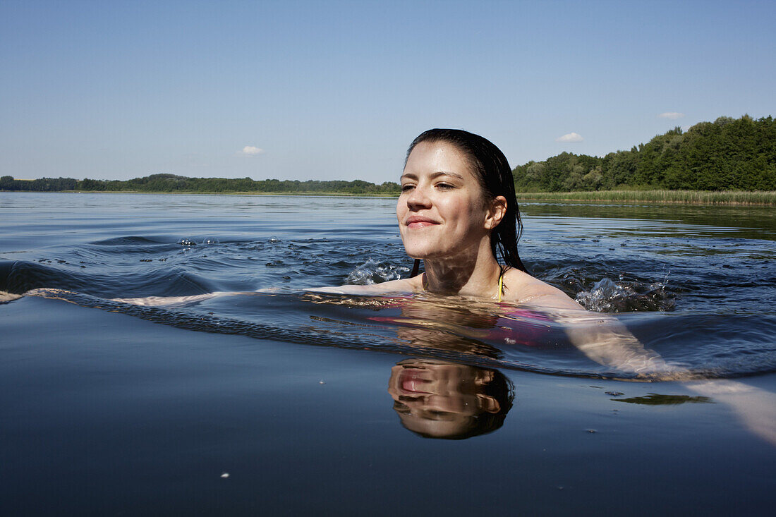 Girl happily swimming in lake